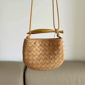 Mini leather shoulder: crossbody bag with sardine shaped handle.